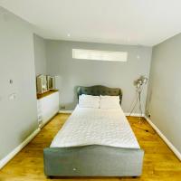 Large king-size bedroom with modern fitted kitchen in Greater London