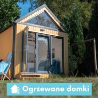a tiny house with a large glass door at Pod Cyprysami - surf & family resort, Jastarnia