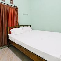 a bed in a room with a red curtain at SPOT ON 91771 Homestay Bang Haji, Praya