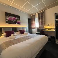 a hotel room with a large bed and a desk at BRIT HOTEL LE VESOUL, Vesoul