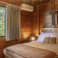 a bedroom with a bed with wooden walls and a window at Selina Poc Na Isla Mujeres