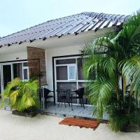 a house with palm trees in front of it at WHITE SAND ARK RESORT, Koh Rong Island