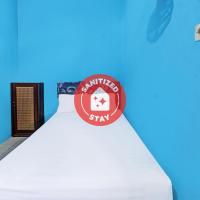 a bed with a sign on top of it at SPOT ON 91811 Rumah Inap Bunda Nurhayati, Praya