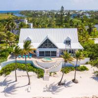 an aerial view of a house on the beach with palm trees at Serene Spacious 3BR Home Private Beach Marine Park, Driftwood Village