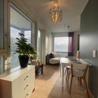 a living room with a table and a dining room at The Wildflower Apartment, Turku