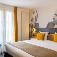a hotel room with a large bed with yellow pillows at Best Western Plus l'Artist Hotel, Tours