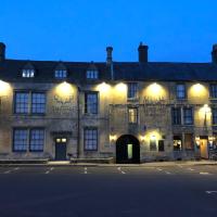 an old building with lights on the side of a street at The Stag at Stow, Stow on the Wold