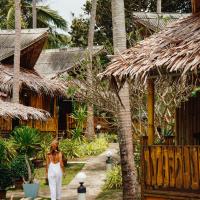 a woman walking down a path in front of a resort at Lazy Days Bungalows, Ko Lanta