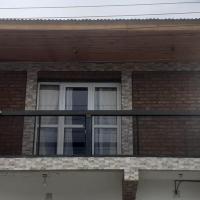 a balcony on a brick building with a window at El lucero, Los Antiguos