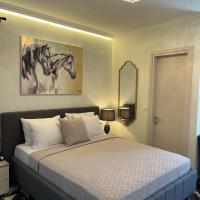 a bedroom with a bed with a painting of a horse on the wall at Aesthesis Arxontiko Luxury Rooms, Myrina