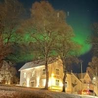 a house with the aurora in the sky at Ami Hotel, Tromsø