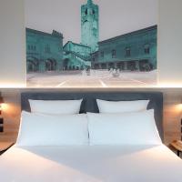 a bedroom with a white bed and a clock tower at Mercure Bergamo Centro Palazzo Dolci