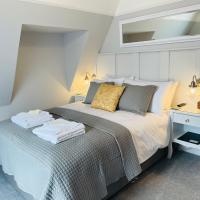 a bedroom with a bed with a mirror on the wall at The Limes, Swanage