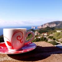 a coffee cup sitting on a plate on a ledge at B&B Pedra Rubia, Nebida