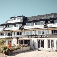a large white building with a sign on it at Hotel Astra Maris, Büsum