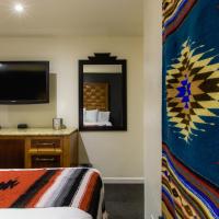 a hotel room with a bed and a tv at Coyote South, Santa Fe