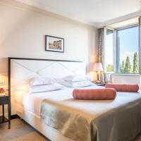 a bedroom with a large bed with a large window at Hotel Park Split