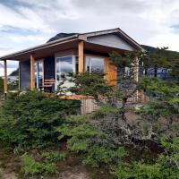 a house on top of a hill with trees at Cabañas Sierra Dorotea, Puerto Natales