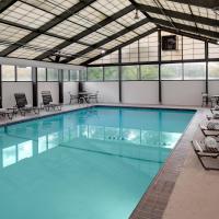 a large swimming pool with chairs and tables at Hyatt Place Princeton
