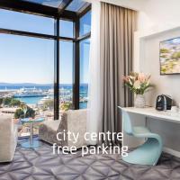a city centre free parking hotel room with a desk and a large window at Hotel Luxe, Split