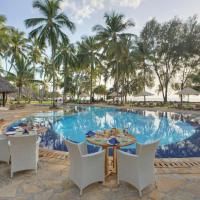 a resort pool with tables and chairs and palm trees at Bluebay Beach Resort & Spa, Kiwengwa