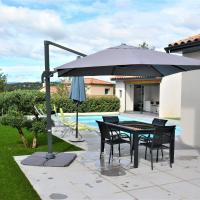 a table and chairs under an umbrella in a yard at Maison Ruoms, 4 pièces, 6 personnes - FR-1-382-96