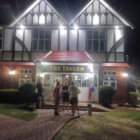 a group of people standing outside of a building at night at The Tavern Lodgings, Ko Phangan