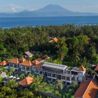 an aerial view of a resort with trees and the ocean at Hotel Arsa Santhi Nusa Penida
