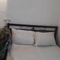 a white bed with two white pillows on it at Fertassa mtls, Moulay Idriss