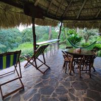 a patio with chairs and a table and a hammock at Eco-Lodge El Porvenir., Santa Cruz