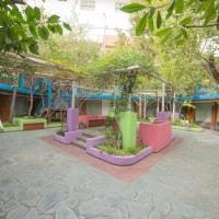 a courtyard with colorful benches and trees in front of a building at El Prado, Neuquén
