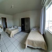 a bedroom with two beds and a large window at Hamara Soft Hotel 1, Altamira