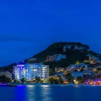 a view of a city from the water at night at Atrium Beach Resort and Spa St Maarten a Ramada by Wyndham, Simpson Bay
