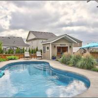 a swimming pool in front of a house at Living the Dream with Inground Heated Pool, Hot Tub, & Beach, Cobourg