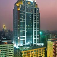 a tall building with a clock on top of it at Asia International Hotel Guangdong, Guangzhou