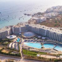 an aerial view of a resort next to the ocean at db Seabank Resort + Spa All Inclusive, Mellieħa
