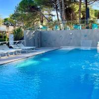 a swimming pool with chairs and a swimming pool at Hotel President, Lignano Sabbiadoro