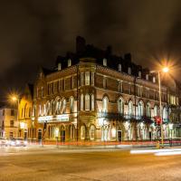 a large building on the corner of a street at night at The Duke of Edinburgh Hotel & Bar, Barrow in Furness
