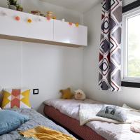 a bedroom with two beds and a window at Camping Mussonville, Soulac-sur-Mer