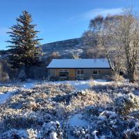 a house in a field covered in snow at Cairn Shiel, Achnasheen