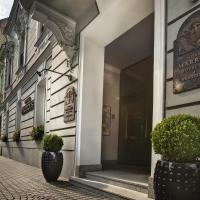 a building with two potted plants on a street at Marrol's Boutique Hotel, Bratislava