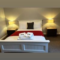 a bedroom with a bed with two towels on it at The Hinds Head Hotel, Chorley
