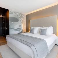 a bedroom with a large white bed in a room at Select Hotel Maastricht