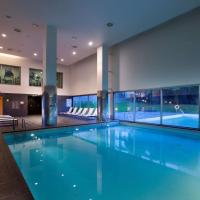 a large swimming pool in a building at NH Collection Santiago de Compostela