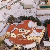 an aerial view of a building with snow covered roofs at Auberge Tourtite, Ifrane
