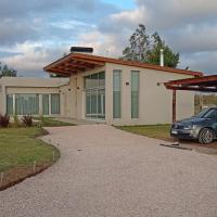 a house with a car parked in front of it at ELONCE, Balneario Claromecó