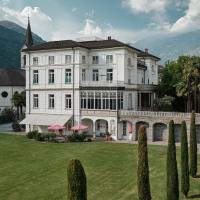 a large white house with a grass yard at Business Center IN Villa, Bellinzona