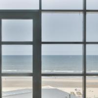 a view of the ocean from a window at Appartement met zeezicht in Bloemendaal
