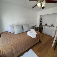 a bedroom with a bed and a ceiling fan at La Cuevita, Studio w/private patio, Laundry, CSUN, Lake Balboa, Getty, Encino