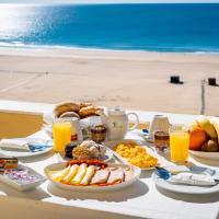 a table with breakfast foods and drinks on the beach at Hotel Santa Catarina Algarve, Portimão